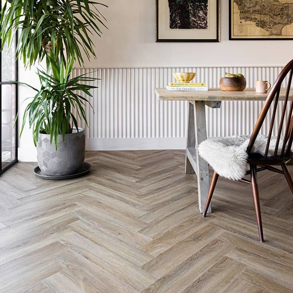 Wide shot of a dining area featuring Harvey Maria Flaxen Oak Herringbone flooring