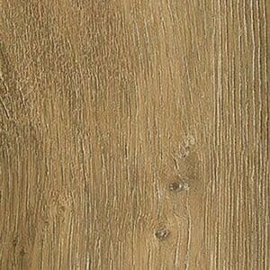 Close up of Flaxen Oak Herringbone flooring next to a wooden table and white sheepskin rug