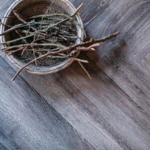 Close up sample of Harvey Maria Garden Oak Herringbone wood effect luxury vinyl tile