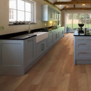 Harvey Maria Honey Oak Plank installed in a large traditional kitchen with blue cabinetry