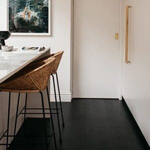 Modern kitchen featuring black Lamp Oak parquet flooring and white cabinetry