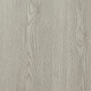 Harvey Maria Pale Oak Plank flooring installed in a bright bedroom with a grey chevron throw