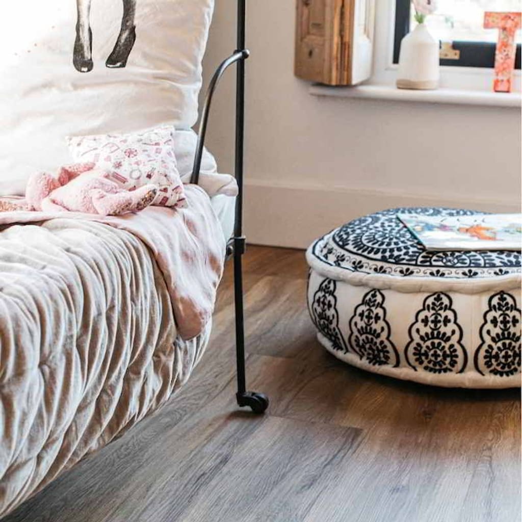 Wide view of Harvey Maria Mid Oak flooring installed in a modern bedroom with natural light