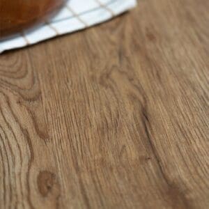 Top down view of Mulberry Plank flooring next to a wooden bowl of bagels