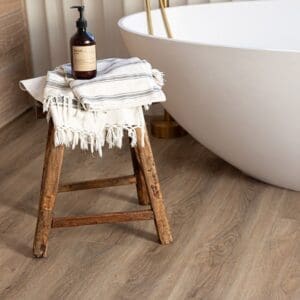 Light oak wood effect vinyl planks in a child's bedroom with a white bed and vintage toy car