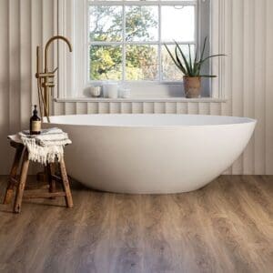 Wide angle view of Oast Plank flooring in a bright bathroom with a large window