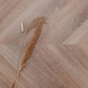 Detailed view of the wood grain surface finish on Old Bramble Chevron flooring