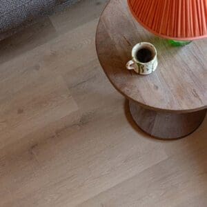 Overhead view of Pale Rattan flooring with a small side table and coffee cup