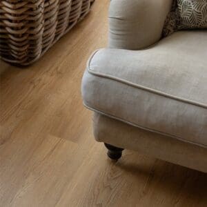 Pippin Plank wood effect flooring underneath a rustic wooden stool