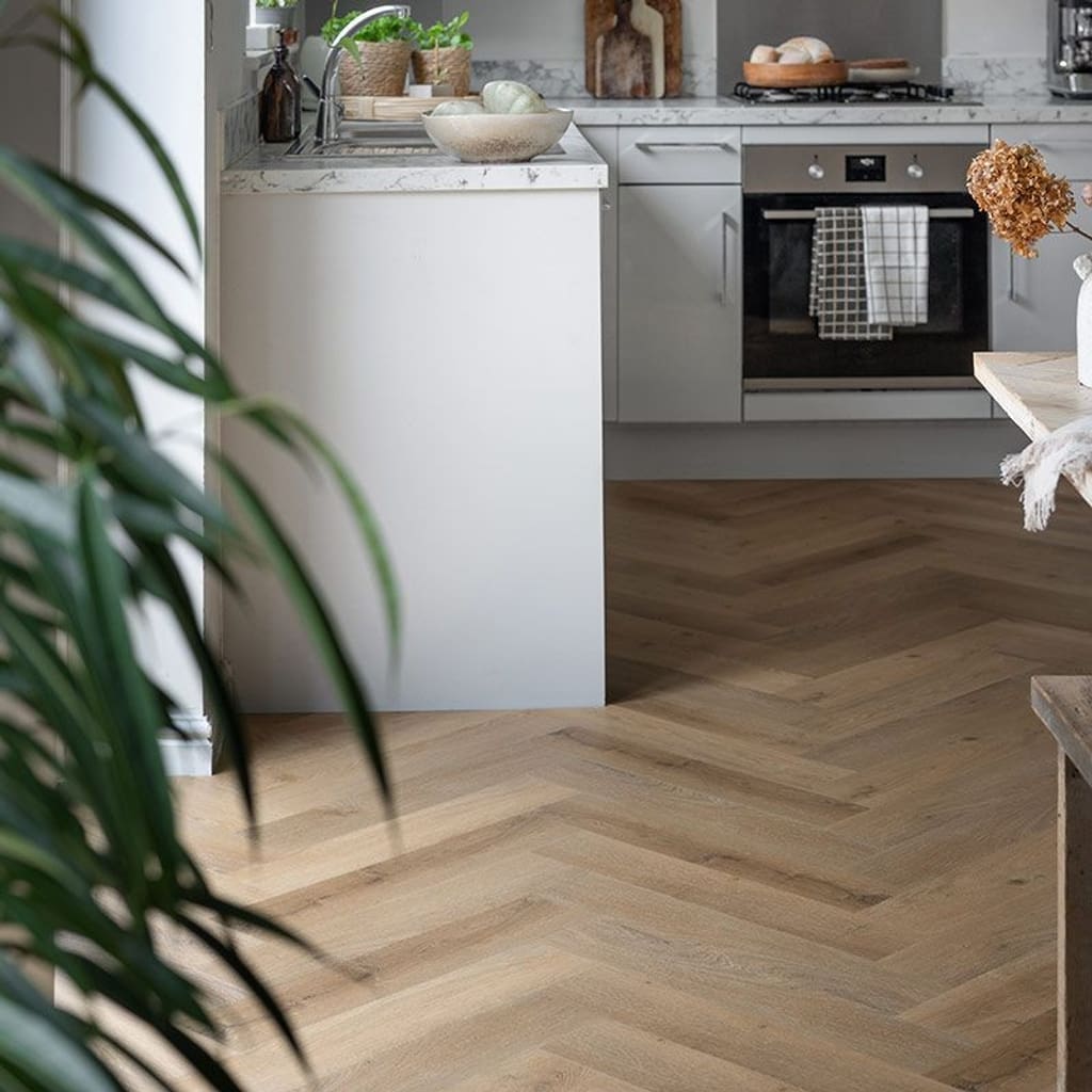 Wide view of Rattan Herringbone flooring in a kitchen and dining space with wooden furniture
