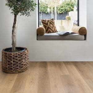 Harvey Maria Rattan Plank flooring in a bright room with a window seat and large potted plant