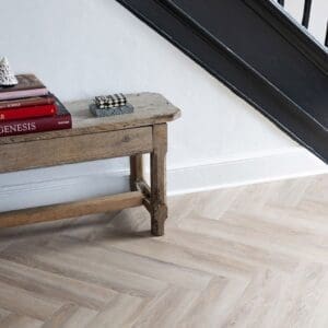 Close up view of Rosehip Herringbone luxury vinyl tiles showing wood grain detail