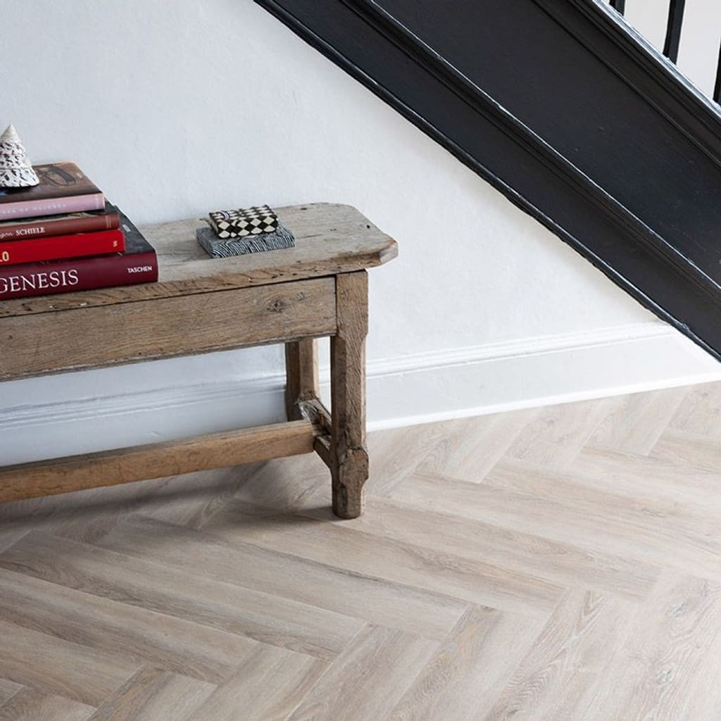 Close up view of Rosehip Herringbone luxury vinyl tiles showing wood grain detail