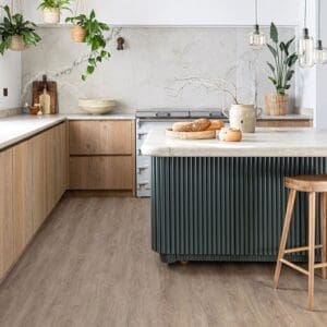 Modern rustic kitchen featuring Rosehip wood effect flooring and a fluted island