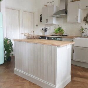 Modern kitchen featuring Spring Oak parquet flooring and a white panelled kitchen island.