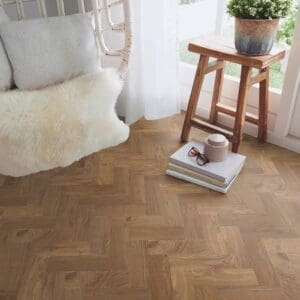 Spring Oak parquet flooring installed in a bright living room with a white chair and wooden stool.