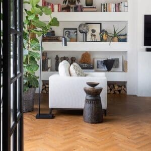 Wide angle view of a stylish interior with Sussex Oak Parquet flooring and biophilic design elements.