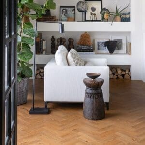 Close up of Sussex Oak Parquet luxury vinyl tile showing realistic wood grain and warm oak tones.