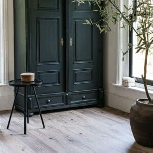 Wood effect vinyl flooring styled with a wicker hanging chair and rustic wooden bench