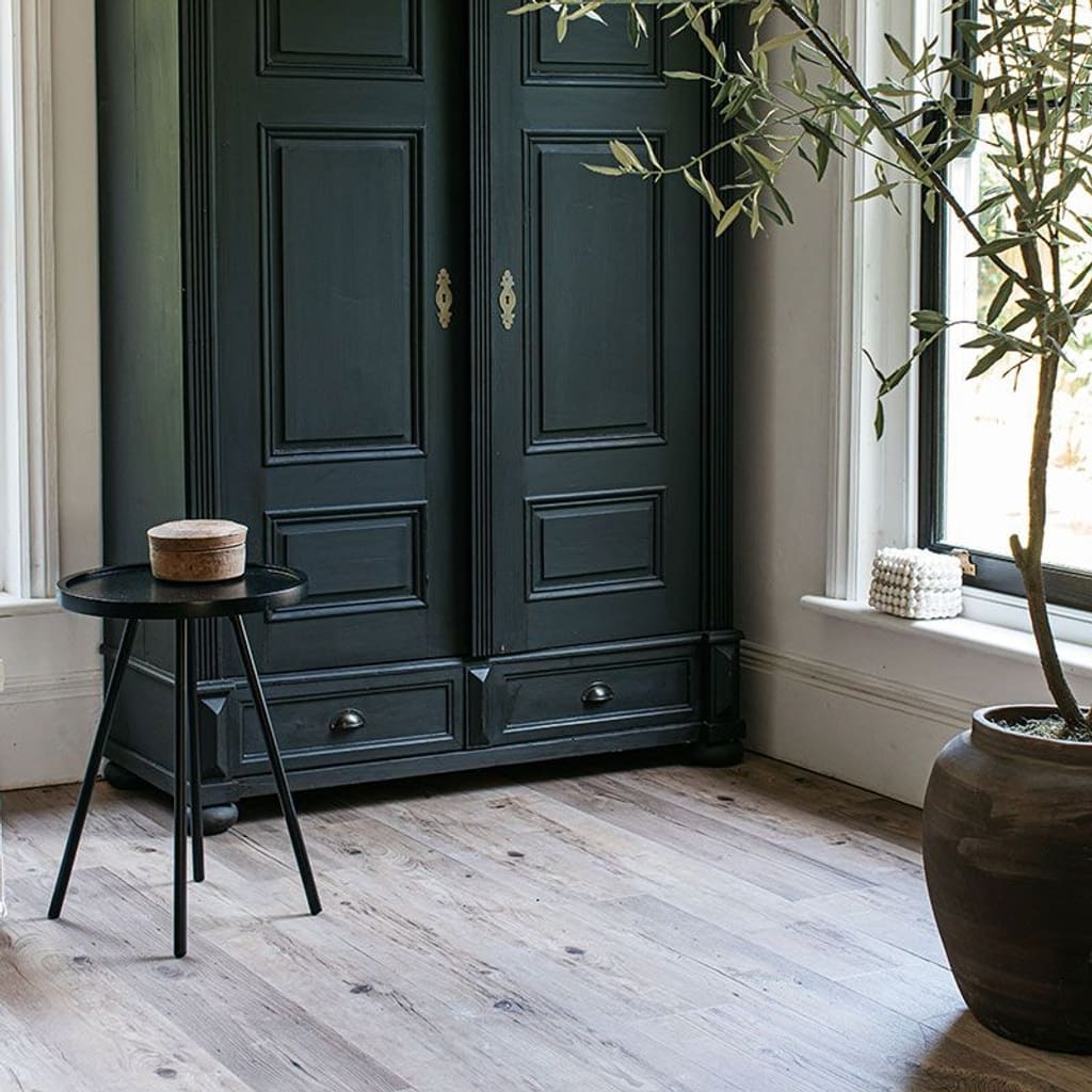 Wood effect vinyl flooring styled with a wicker hanging chair and rustic wooden bench