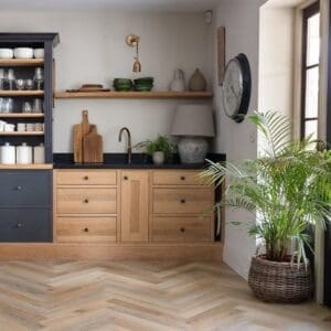 Detailed top-down view of the herringbone pattern and sandy oak tones