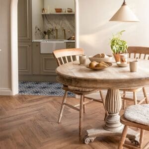 Wildfox Herringbone luxury vinyl flooring installed in a modern white kitchen