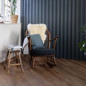 Harvey Maria WildFox Plank installed in a room with a rocking chair and dark panelled wall