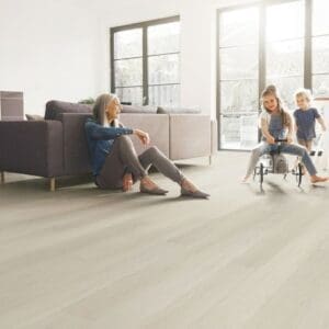 Family living room scene featuring Nordikka Naturals Almond Birch flooring in a bright open space