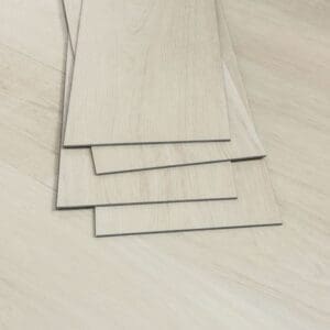 Stacked samples of Nordikka Naturals Almond Birch luxury vinyl planks