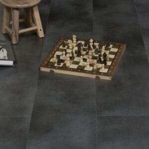 Anthracite flooring tiles in a lifestyle setting with a chess board