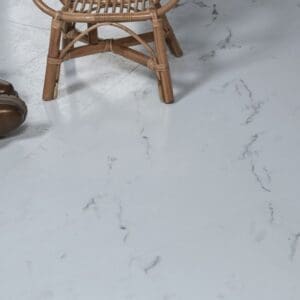 Close up of marble effect flooring with a wicker chair and leather boots
