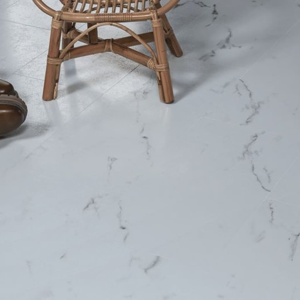 Close up of marble effect flooring with a wicker chair and leather boots
