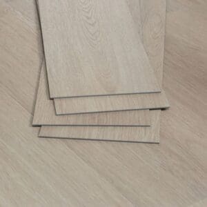 A stack of Nordikka Naturals Oregon Ash vinyl planks showing thickness and edge detail