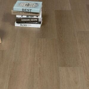 Close up of Saddle Oak flooring with lifestyle props demonstrating the realistic wood effect texture.
