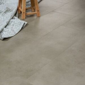 Close up of Sandstone flooring tiles in a home setting with a wooden stool