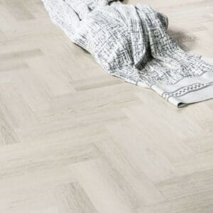 Close up of Pale Birch flooring with a textured blanket showing the realistic wood grain