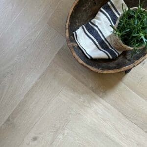 Wide angle view of Pale Rattan Herringbone flooring in a modern home setting.