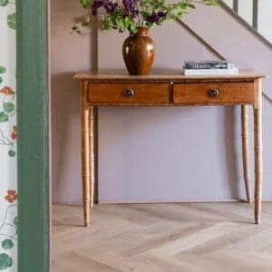Square sample swatch of Pale Rattan wood effect flooring showing natural grain.