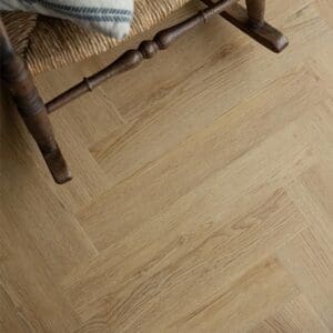 Pippin Herringbone flooring installed in a room with a rustic chair