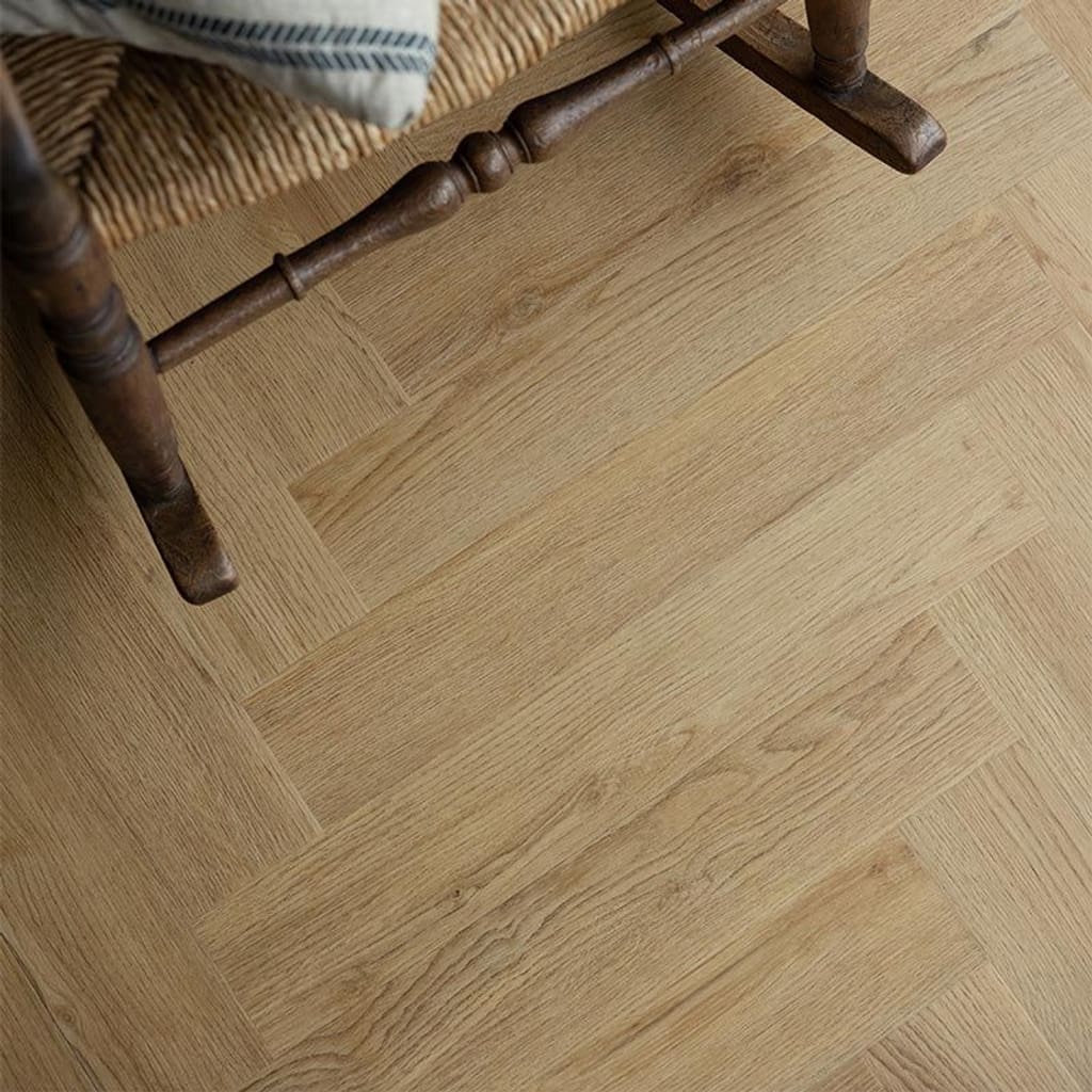 Pippin Herringbone flooring installed in a room with a rustic chair