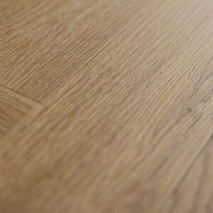 A single plank of Pippin Herringbone showing the golden pine wood effect