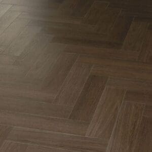Angled close up of dark walnut effect herringbone flooring with light reflecting off the surface