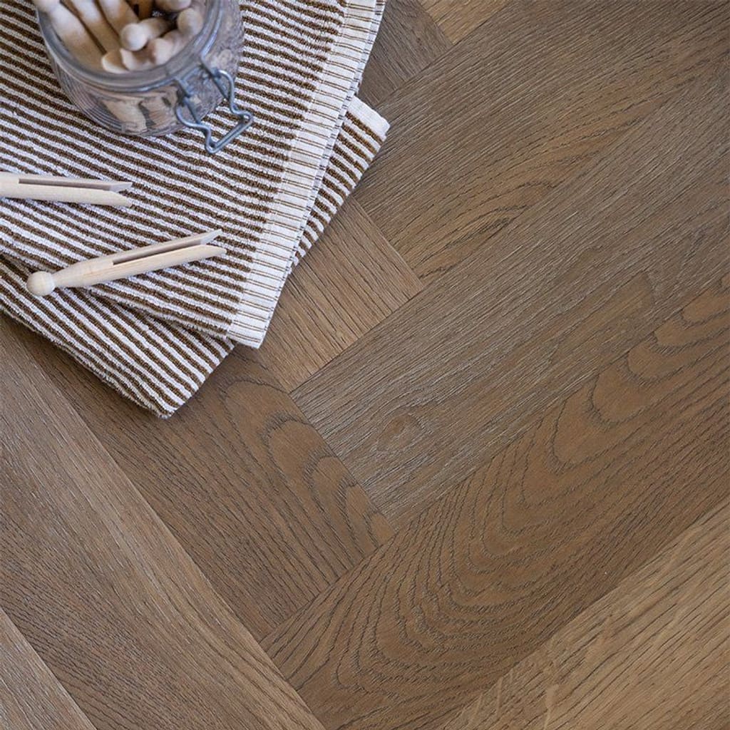 Herringbone pattern flooring styled with books showing the natural variation of the oak tones