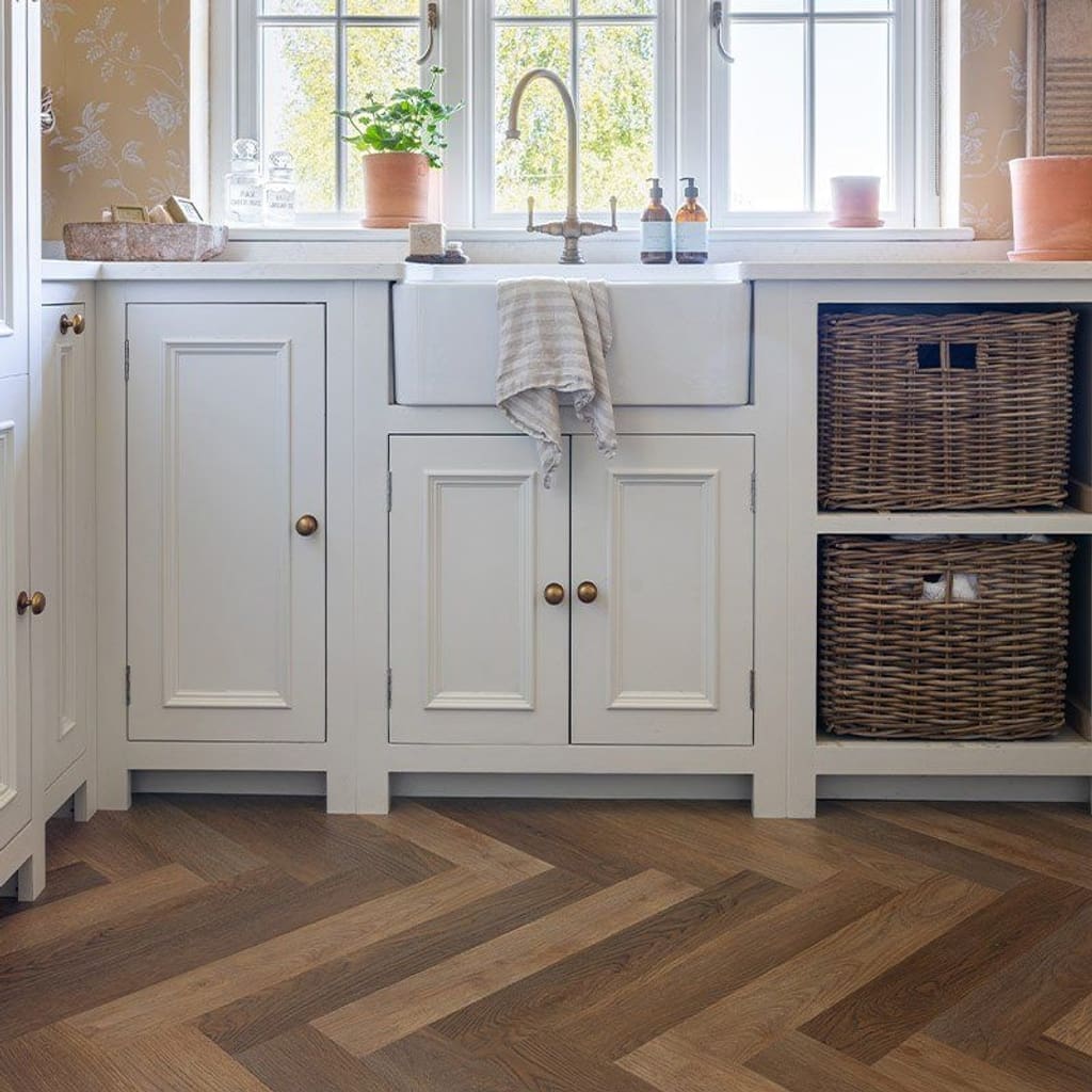 Close up of Rye Herringbone luxury vinyl tile showing wood grain detail and multi-tonal oak shades