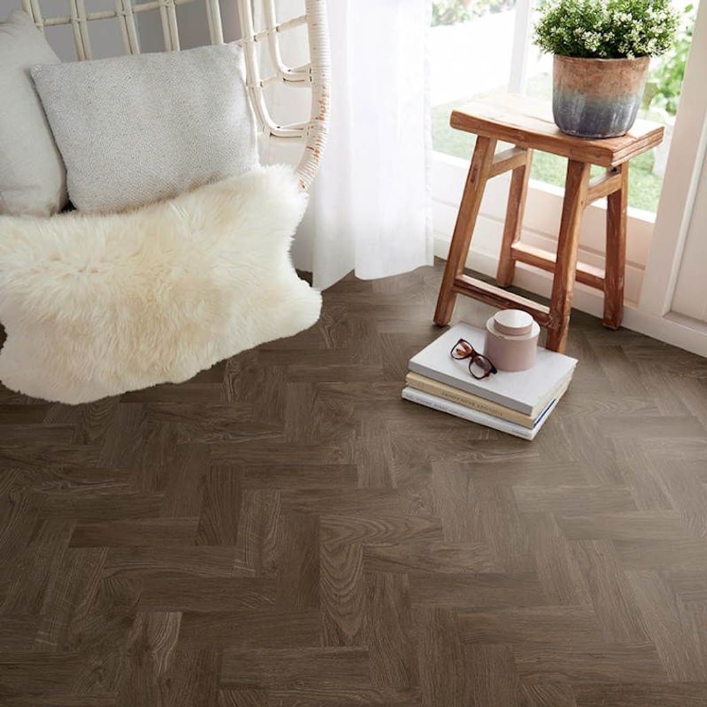 Smoked Oak Parquet flooring in a bright room with a wooden stool and white chair