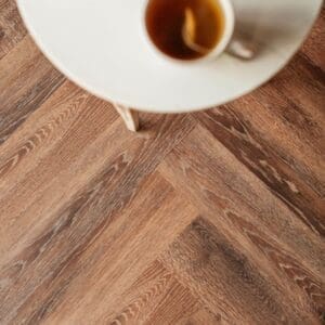 Close up of Toasted Oak wood effect luxury vinyl tile showing grain detail