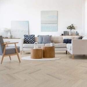 A bright modern living room featuring Vermont Ash herringbone flooring and contemporary furniture.