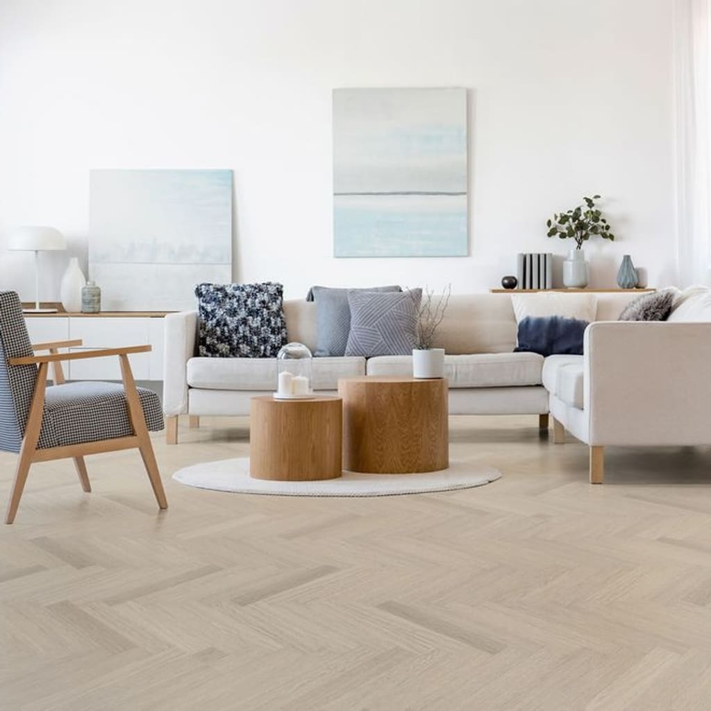 A bright modern living room featuring Vermont Ash herringbone flooring and contemporary furniture.