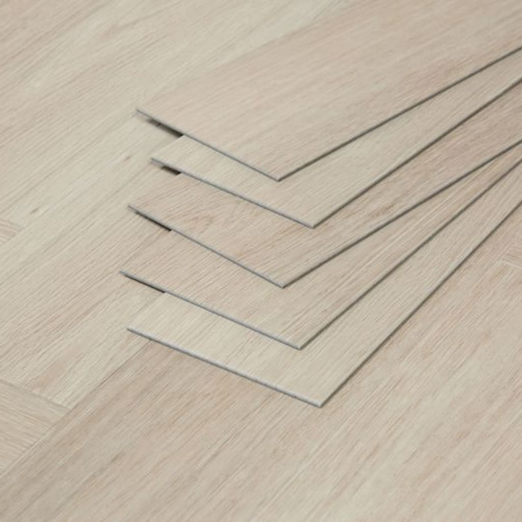 A stack of individual Vermont Ash luxury vinyl planks showing the thickness and profile.