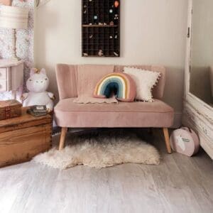 White Oak wood effect flooring in a children's bedroom with pink furniture and rainbow cushion